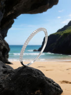 Own Your Bloom moissanite tennis bracelet showcased on beach setting with waves and light, sophisticated minimal jewelry, Boston.