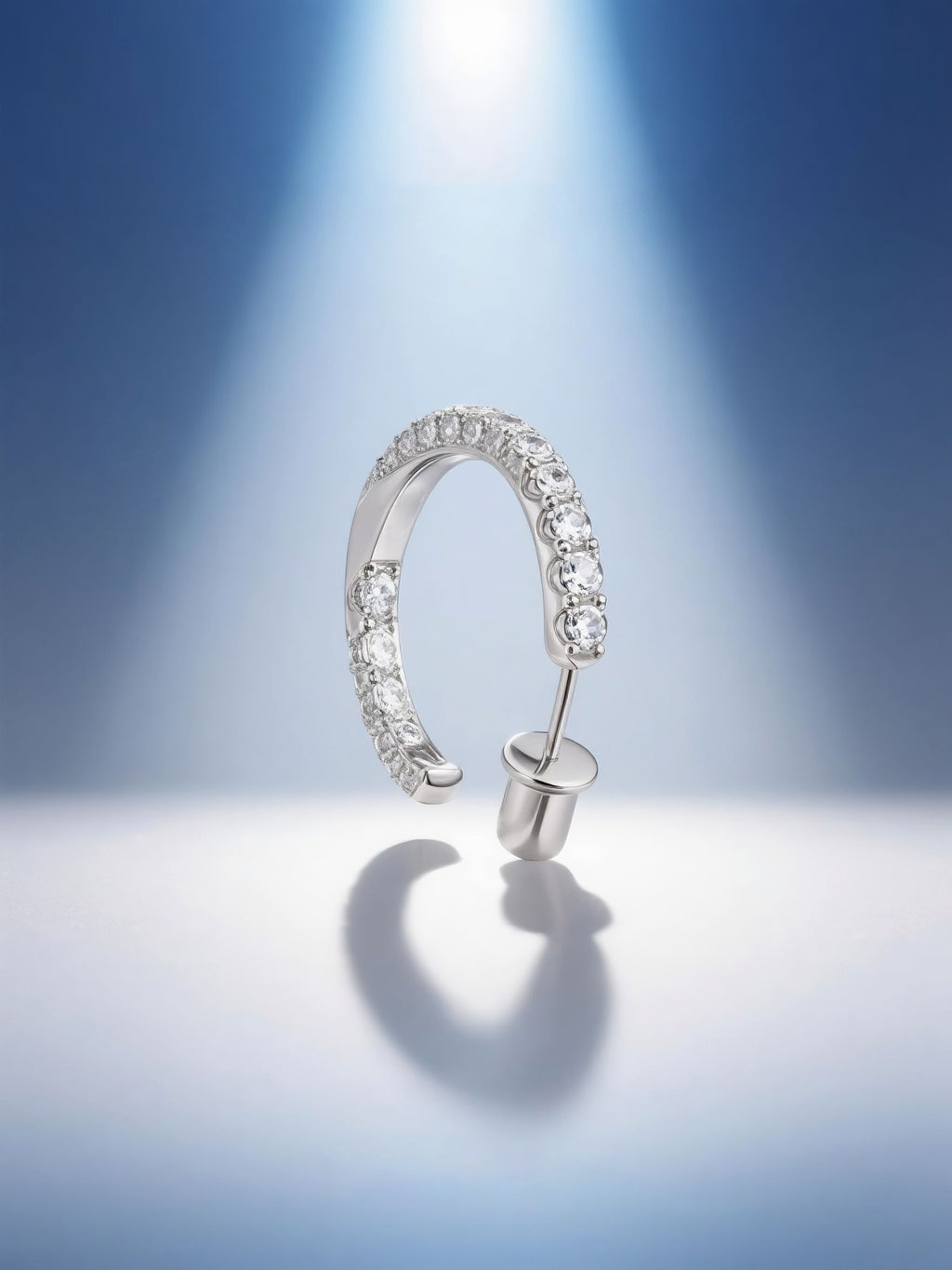 Own Your Bloom moissanite half hoop earrings illuminated by soft blue gradient lighting, modern luxury jewelry photography, Dallas.