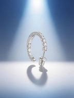 Own Your Bloom moissanite half hoop earrings illuminated by soft blue gradient lighting, modern luxury jewelry photography, Dallas.