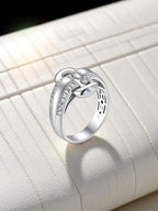 Own Your Bloom moissanite link ring artistic flat lay showing elegant curves and craftsmanship, Boston.