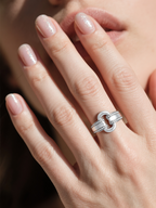 Own Your Bloom moissanite link ring on woman’s hand while playing chess, symbolizing strength and sophistication, Miami.
