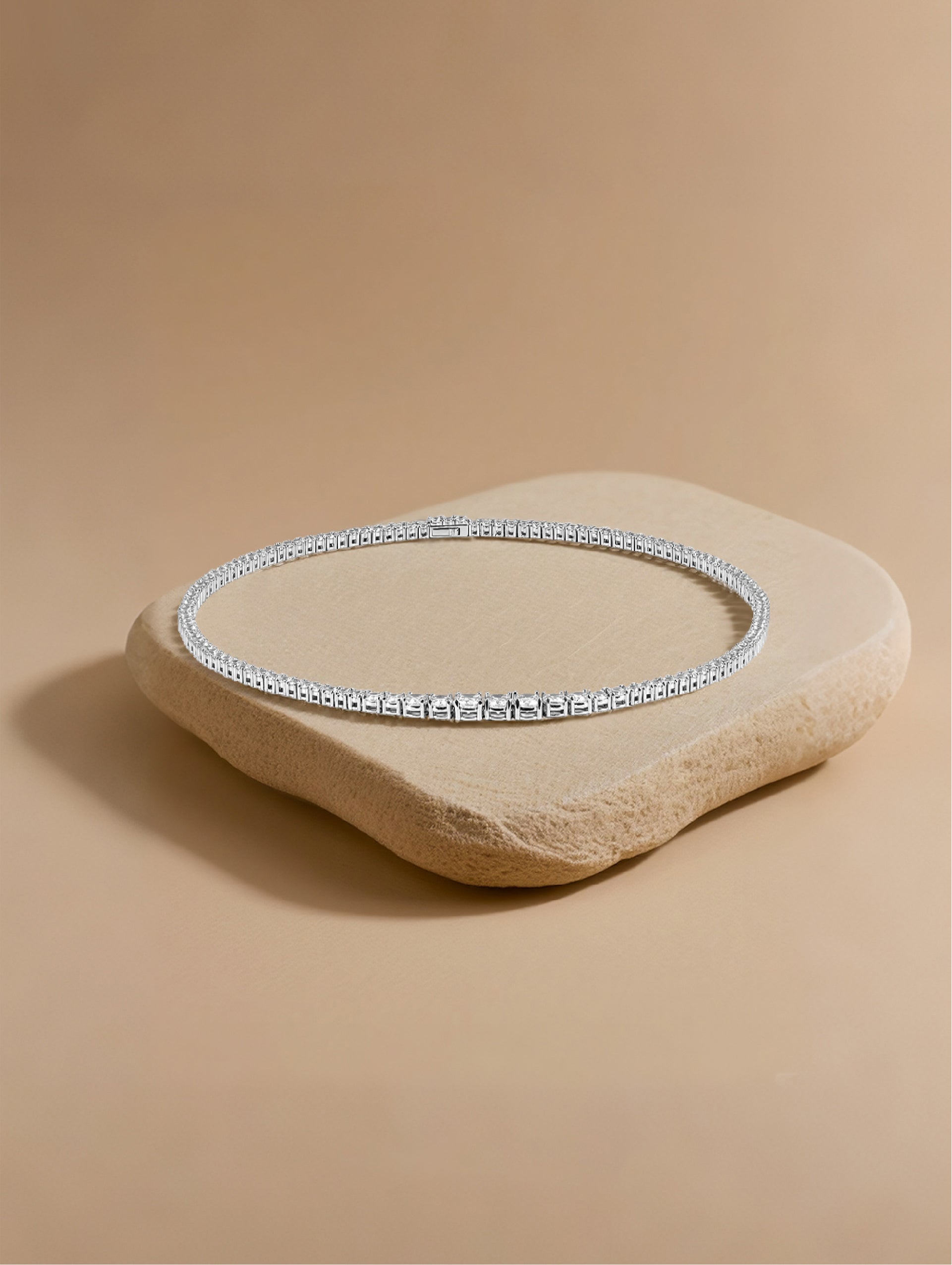 Own Your Bloom moissanite tennis necklace photographed under warm daylight on stone texture, Dallas.