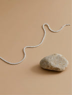 Own Your Bloom 14K tennis necklace with moissanite stones displayed on soft beige background, contemporary elegance, Boston.