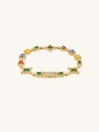 Own Your Bloom 14K gold bracelet with multicolor gemstones and diamonds, flat lay on clean white background, Chicago.