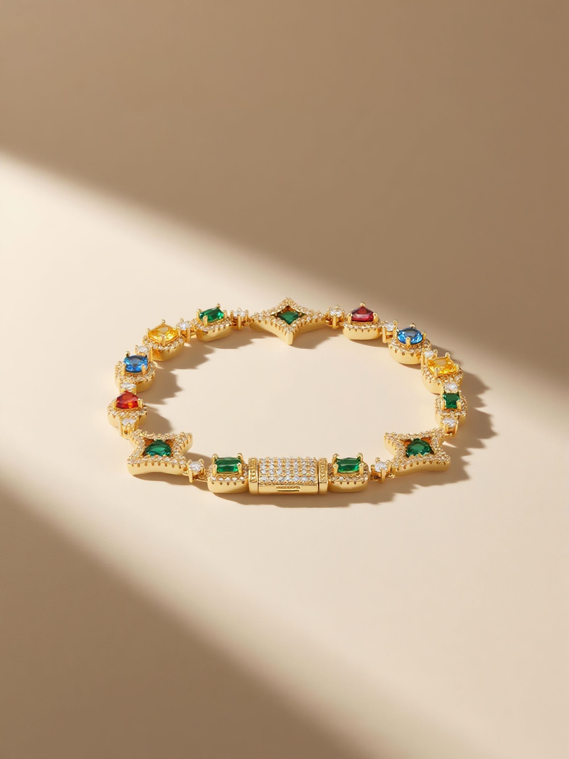 Own Your Bloom multicolor 14K gold diamond bracelet styled on sand with driftwood and gemstones, lifestyle composition, Los Angeles.