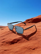 Own Your Bloom black frame narrow sunglasses resting on sandstone canyon, premium eyewear desert photography, Arizona.