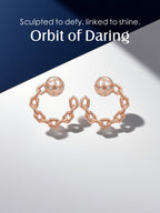 Own Your Bloom Orbit of Daring Earrings reflecting on glossy surface, symbolizing bold femininity and refined design, Boston.