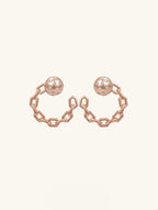 Own Your Bloom Orbit of Daring Rose Gold Crystal Chain Hoop Earrings front view showcasing geometric chain and crystal detailing, New York.