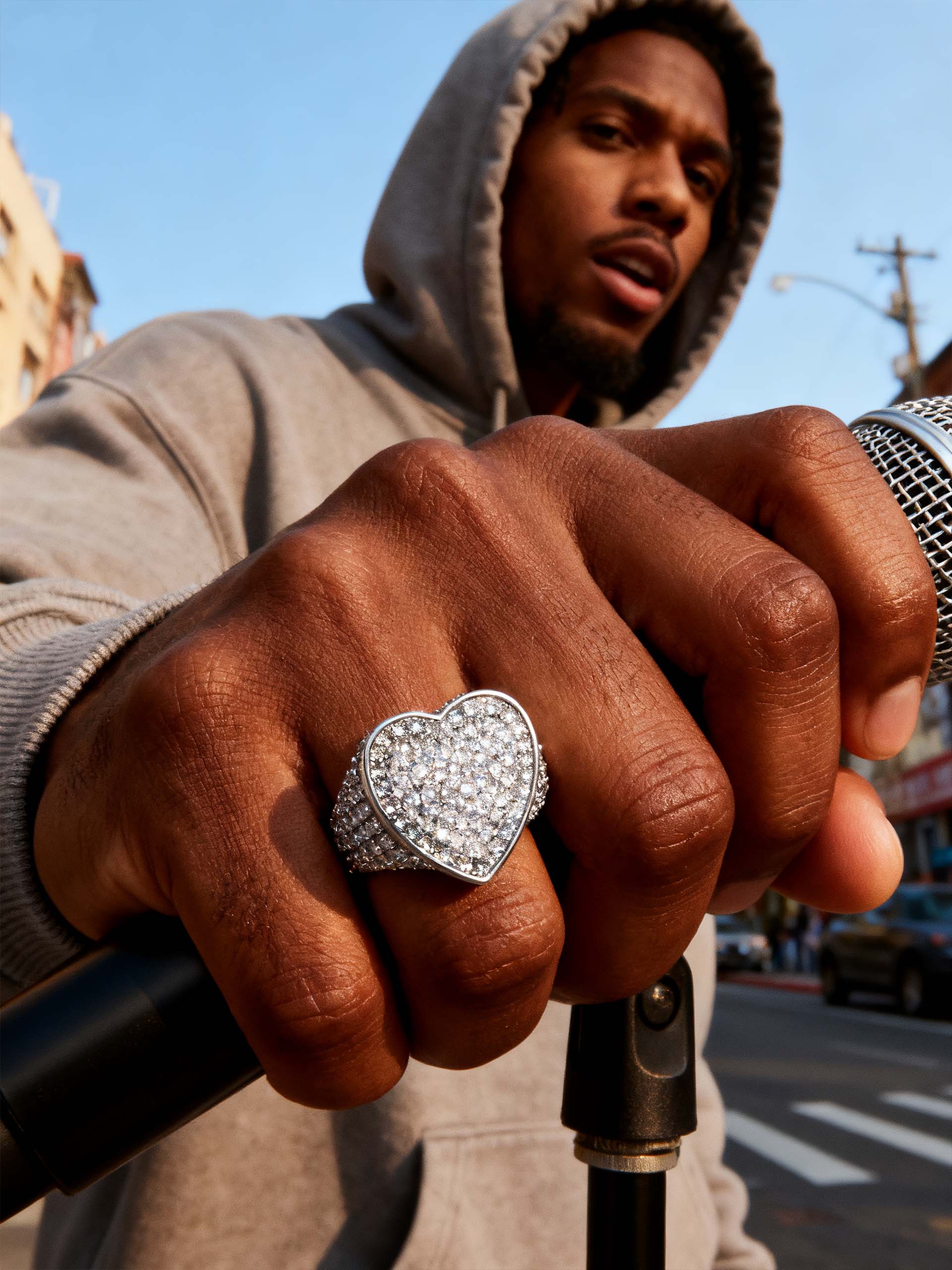 Casual portrait showing Own Your Bloom pavé heart ring on hand with layered sparkle.