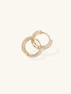 Flatlay of Own Your Bloom pavé hoop earrings showing polished gold-plated finish.