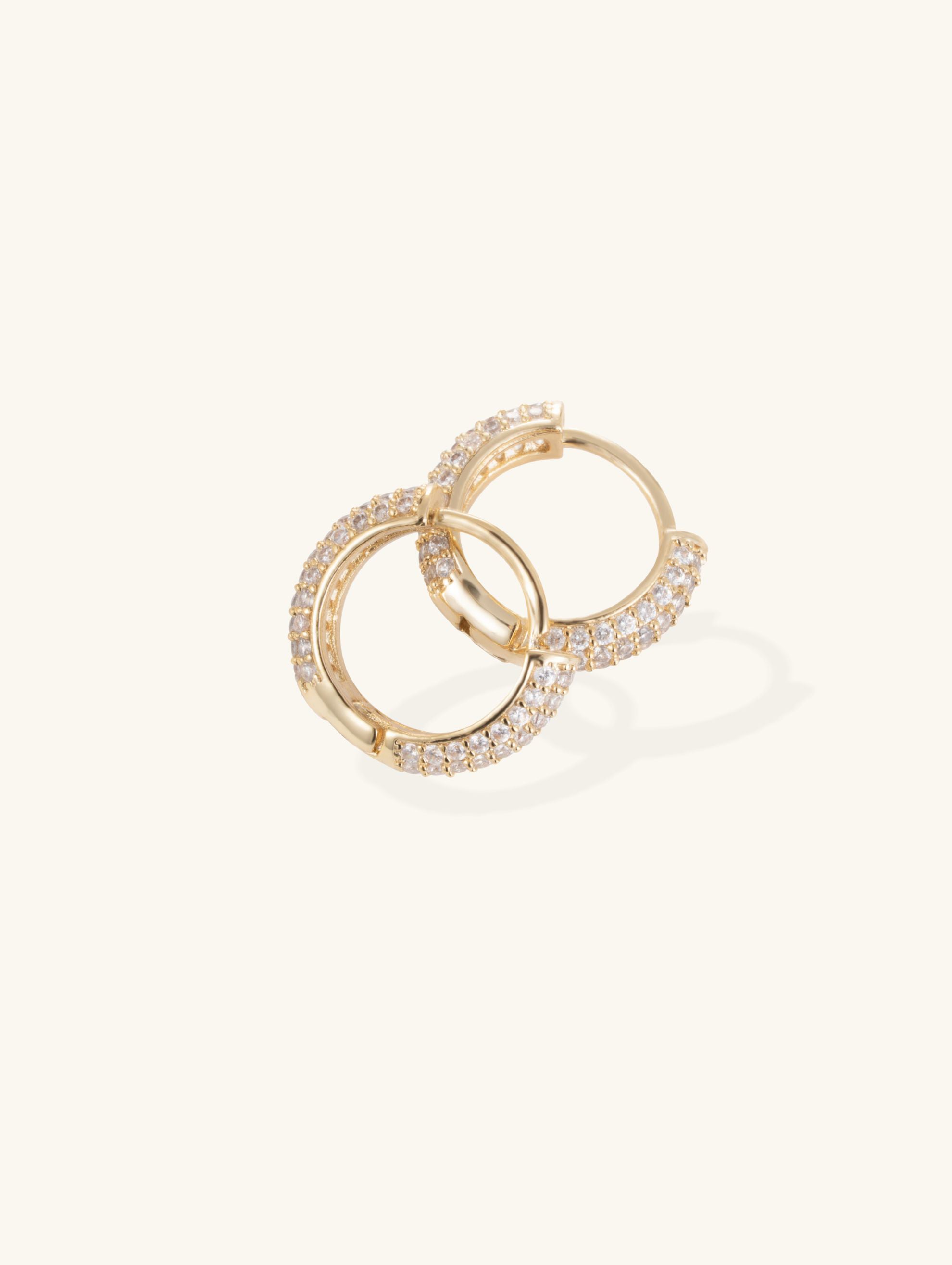 Flatlay of Own Your Bloom pavé hoop earrings showing polished gold-plated finish.
