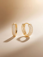 Angled studio shot of a single Own Your Bloom pavé hoop earring with sparkling stones.