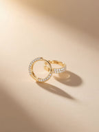 Paired Own Your Bloom pavé hoop earrings in soft light showing curved profile.