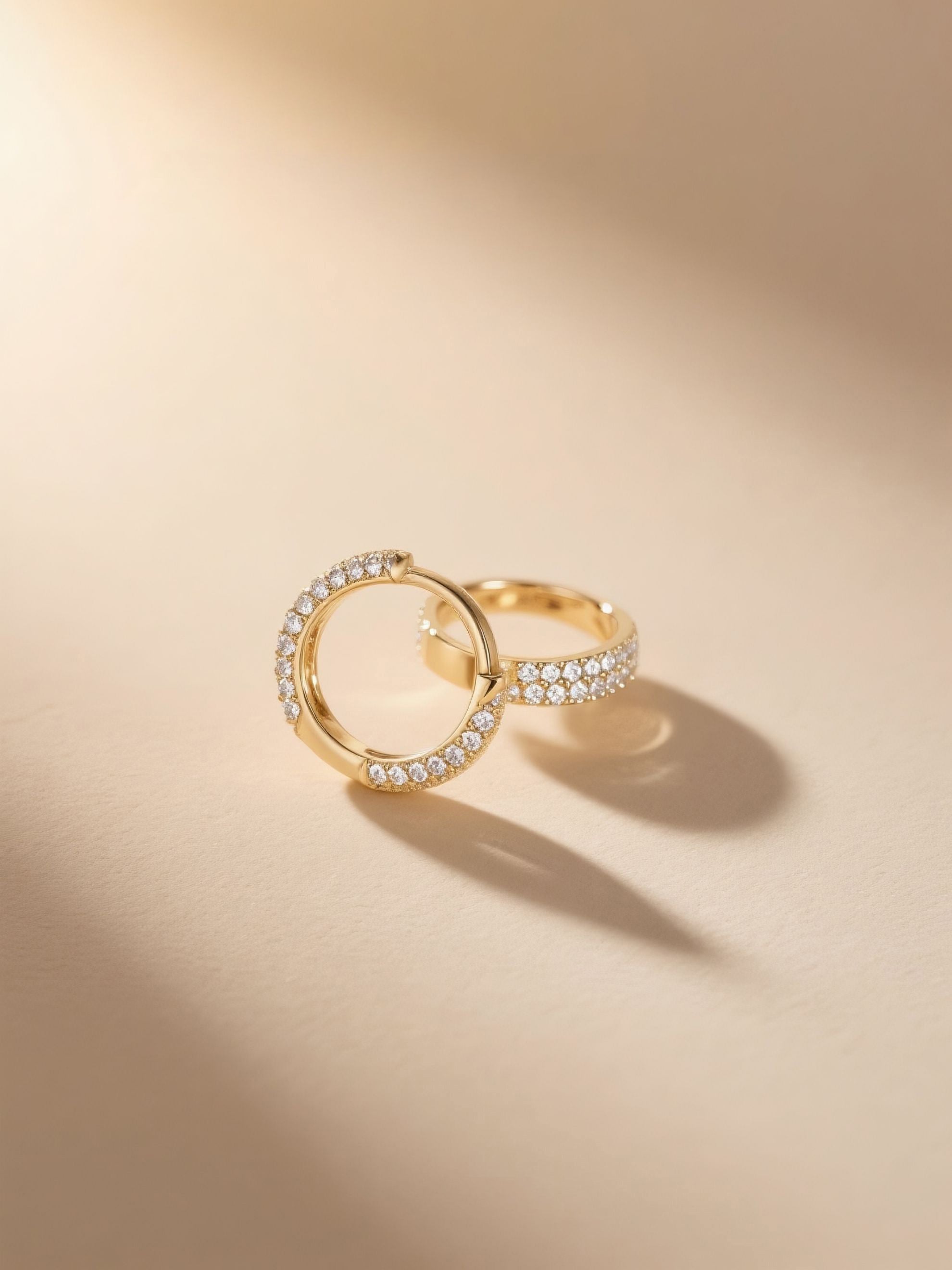 Paired Own Your Bloom pavé hoop earrings in soft light showing curved profile.