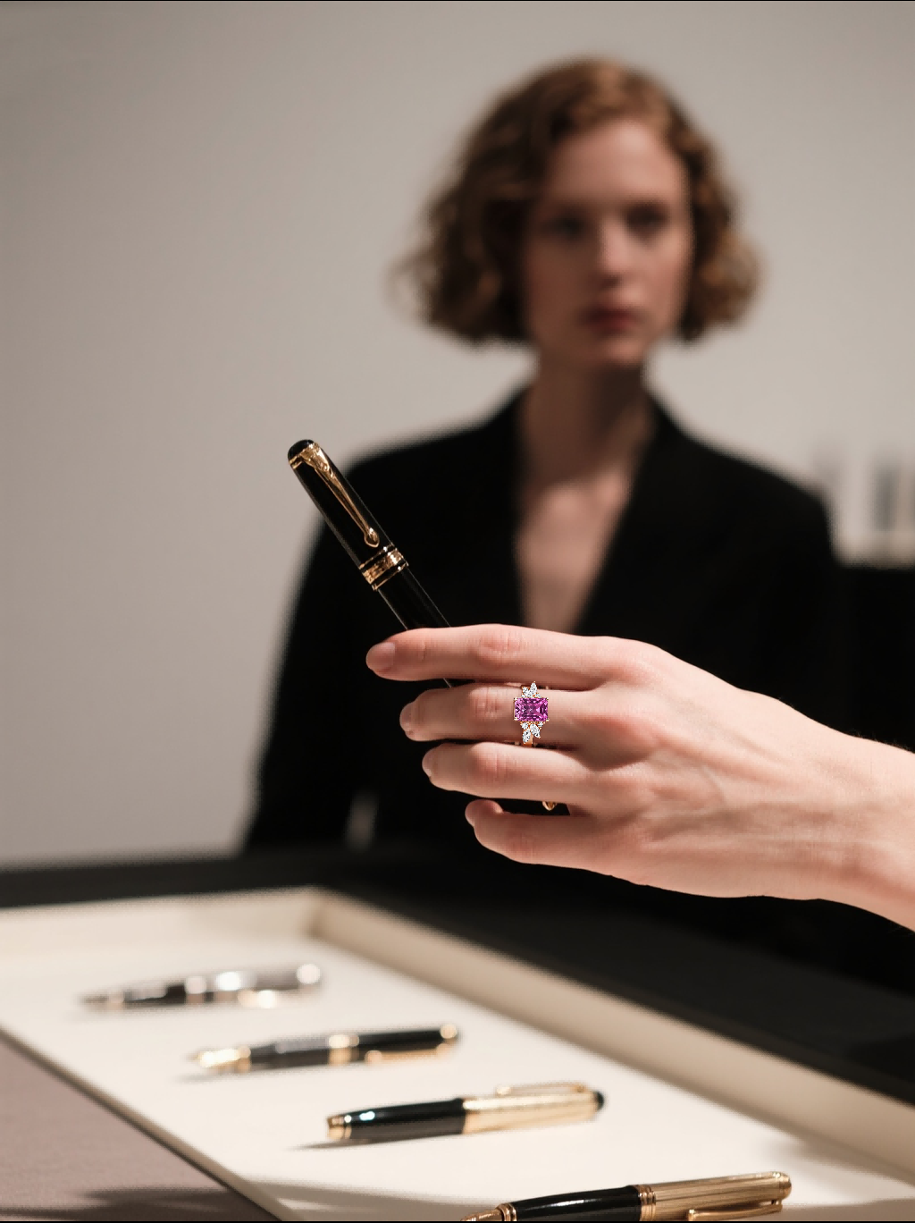 Own Your Bloom rose gold 14K diamond ring with pink center stone worn by woman writing, elegant jewelry lifestyle, Los Angeles.