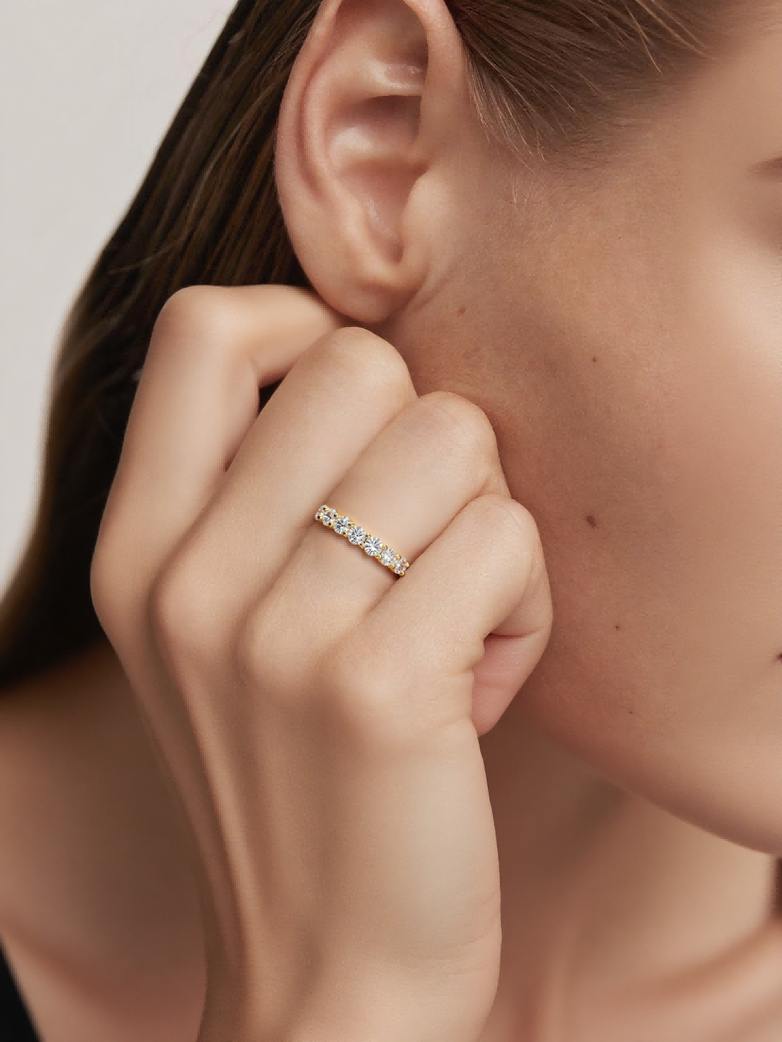 On-hand portrait showing the Own Your Bloom yellow gold–plated prong-set eternity ring worn on finger.