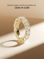 Flat-lay scene of the Own Your Bloom full-circle diamond eternity ring in warm light.