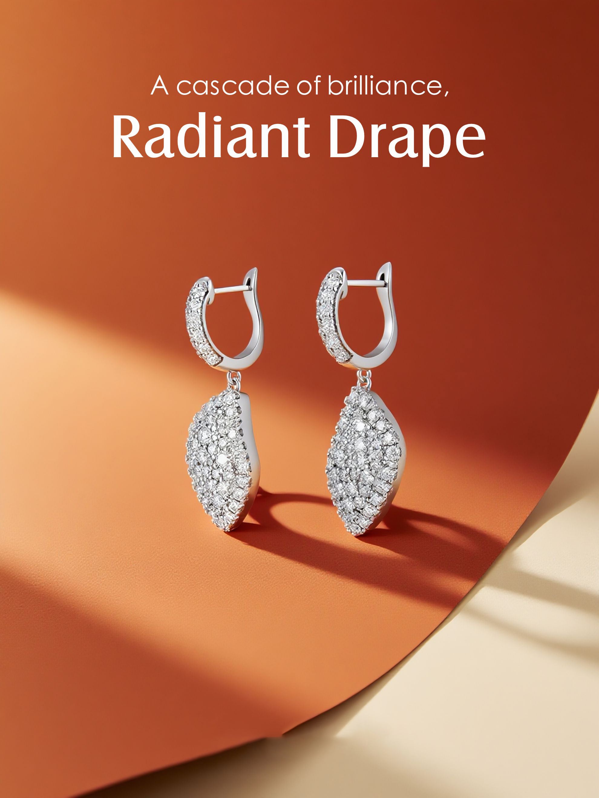 Own Your Bloom radiant drape moissanite earrings displayed on abstract orange backdrop with gentle shadow play, fine jewelry artistry, Boston.