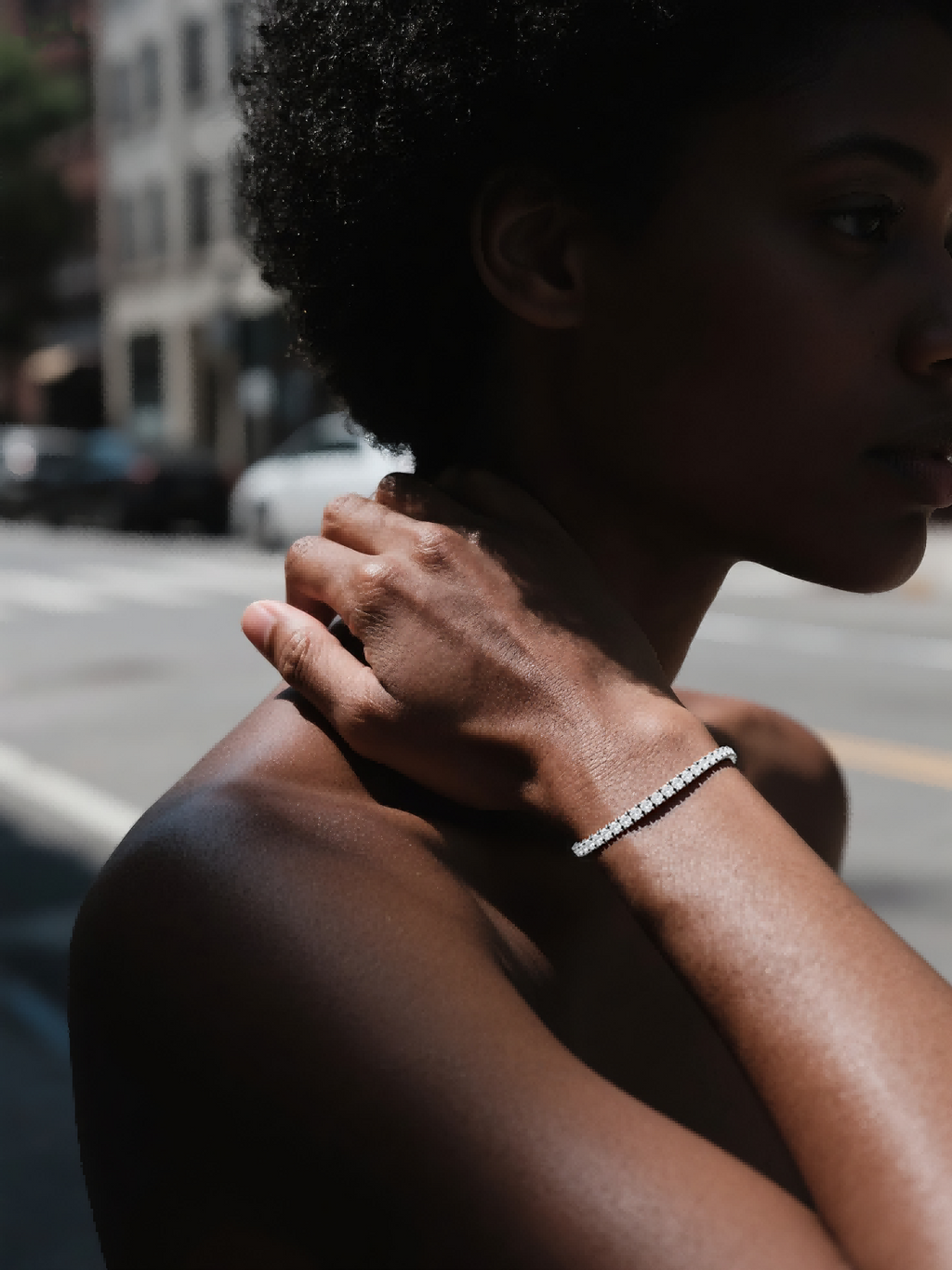 Own Your Bloom Gold Tennis Bracelet on woman’s wrist under sunlight, modern minimal luxury jewelry style, Los Angeles.