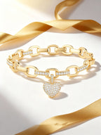 Own Your Bloom Heart Charm Chain Bracelet flatlay composition with soft light reflection and romantic golden tone, Dallas.