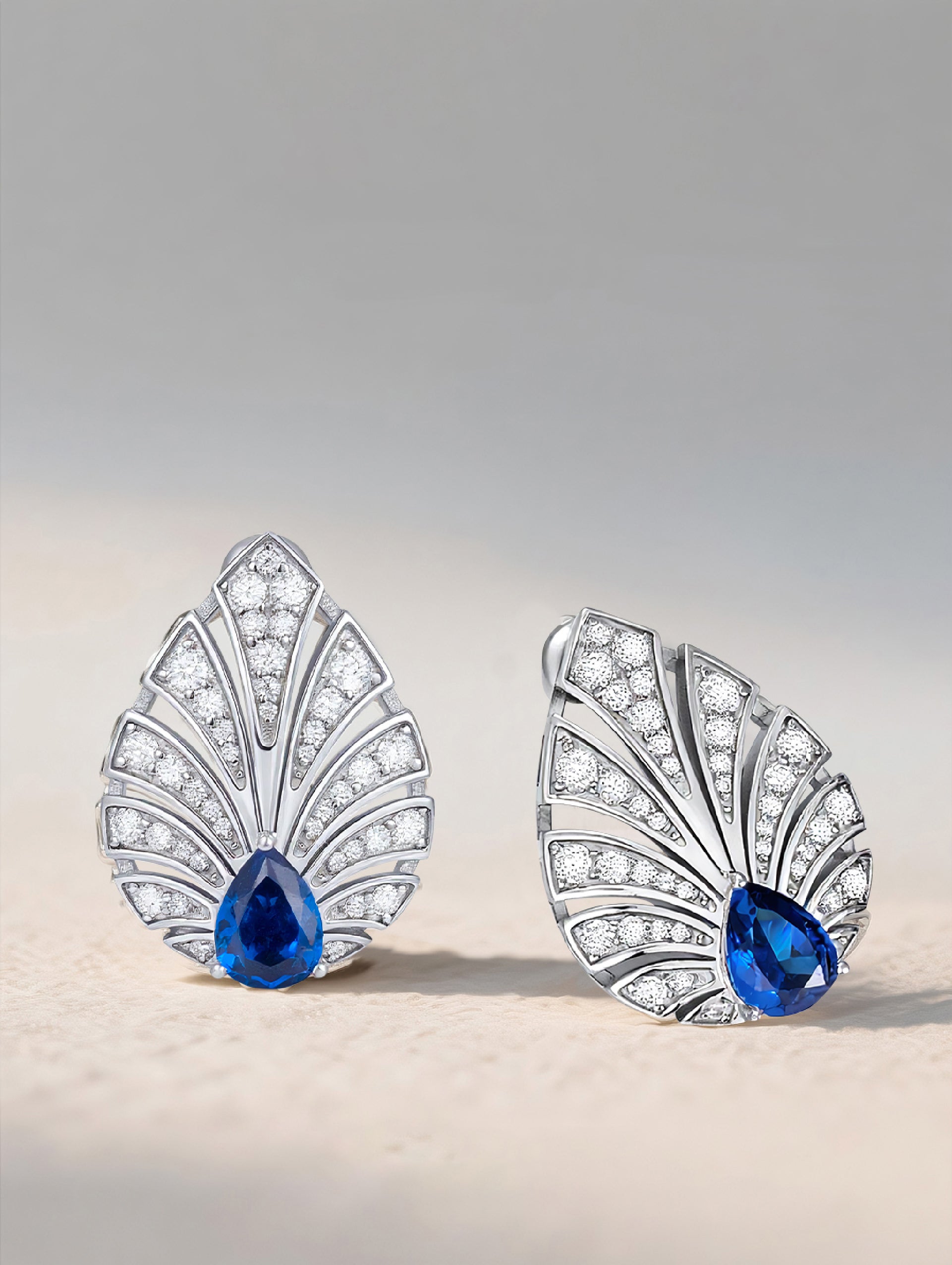 Own Your Bloom Brilliant Gleam sapphire earrings displayed on natural stone background, luxurious blue gemstone and refined design, Miami.