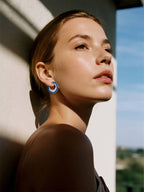 Own Your Bloom sapphire hoop earrings on woman under natural light, showcasing refined elegance and modern style, Los Angeles.