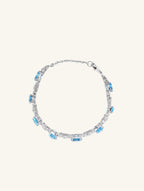 Own Your Bloom blue sapphire tennis bracelet side view showcasing radiant gemstone arrangement and refined craftsmanship, Los Angeles.