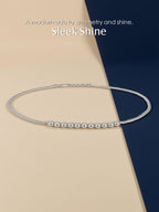 Own Your Bloom silver bezel moissanite necklace displayed on soft beige and navy background with elegant studio lighting, Miami.