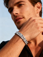 Own Your Bloom Gleam Grid Structured Crystal Bracelet worn by man with white shirt in city scene, symbolizing confidence and luxury, New York.