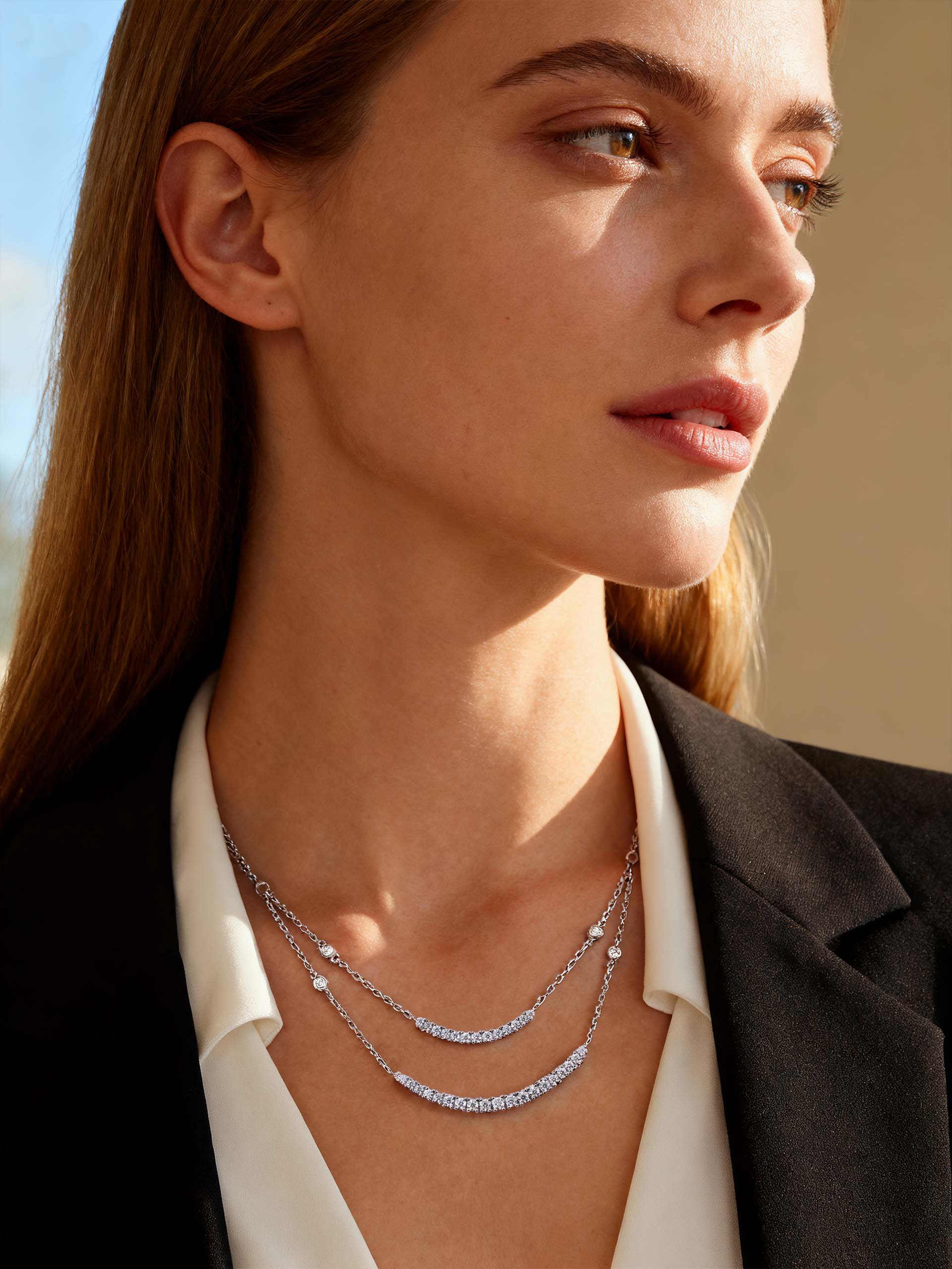 Own Your Bloom Silver Layered Necklace on woman paired with blazer and white blouse, expressing refined elegance, Los Angeles.