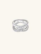 Own Your Bloom silver diamond crossover ring side angle showing intertwined design and polished surface, Los Angeles.