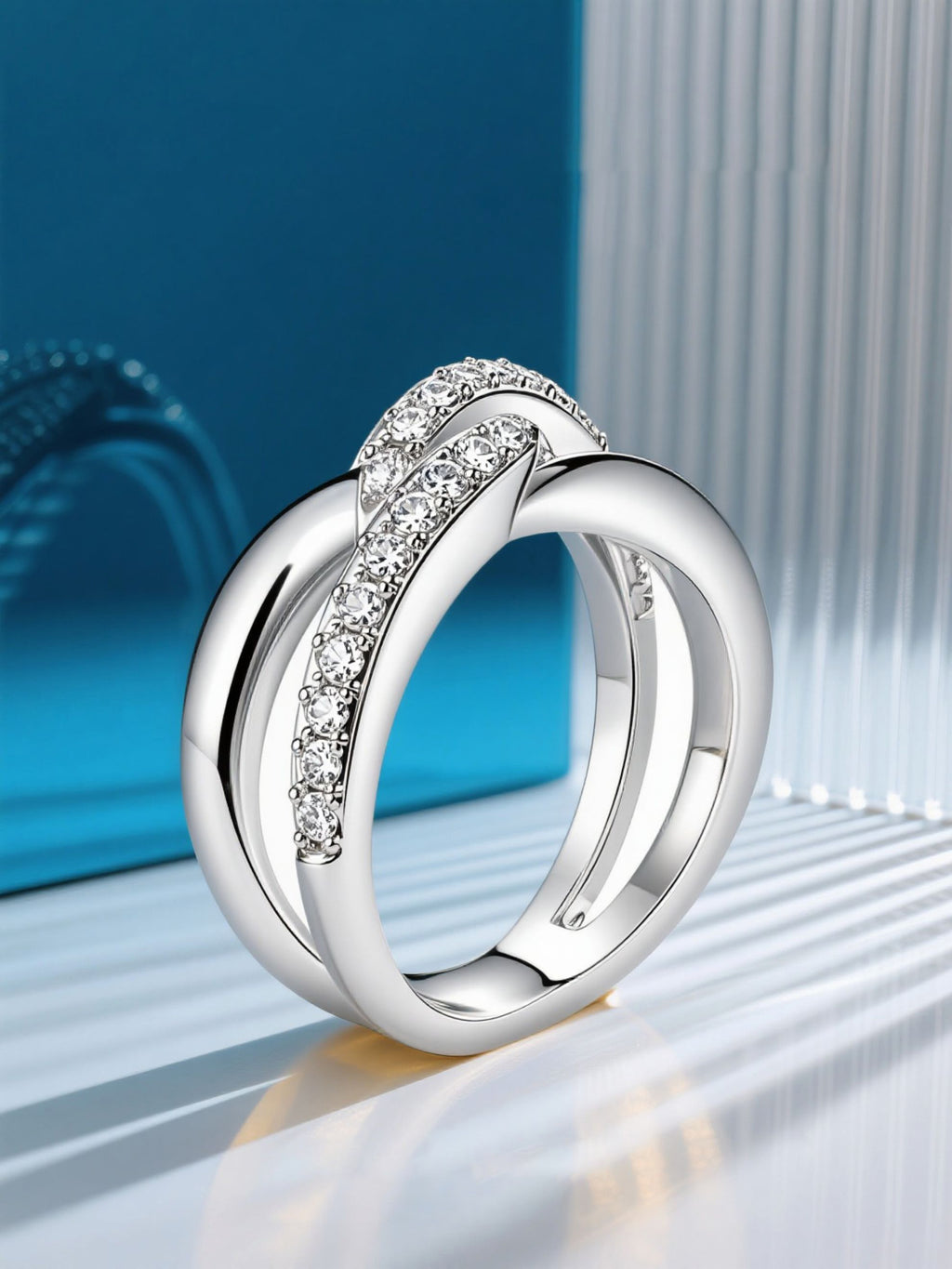 Own Your Bloom silver crossover ring displayed on clean minimal background emphasizing brilliance and strength, Boston.