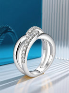 Own Your Bloom silver crossover ring displayed on clean minimal background emphasizing brilliance and strength, Boston.