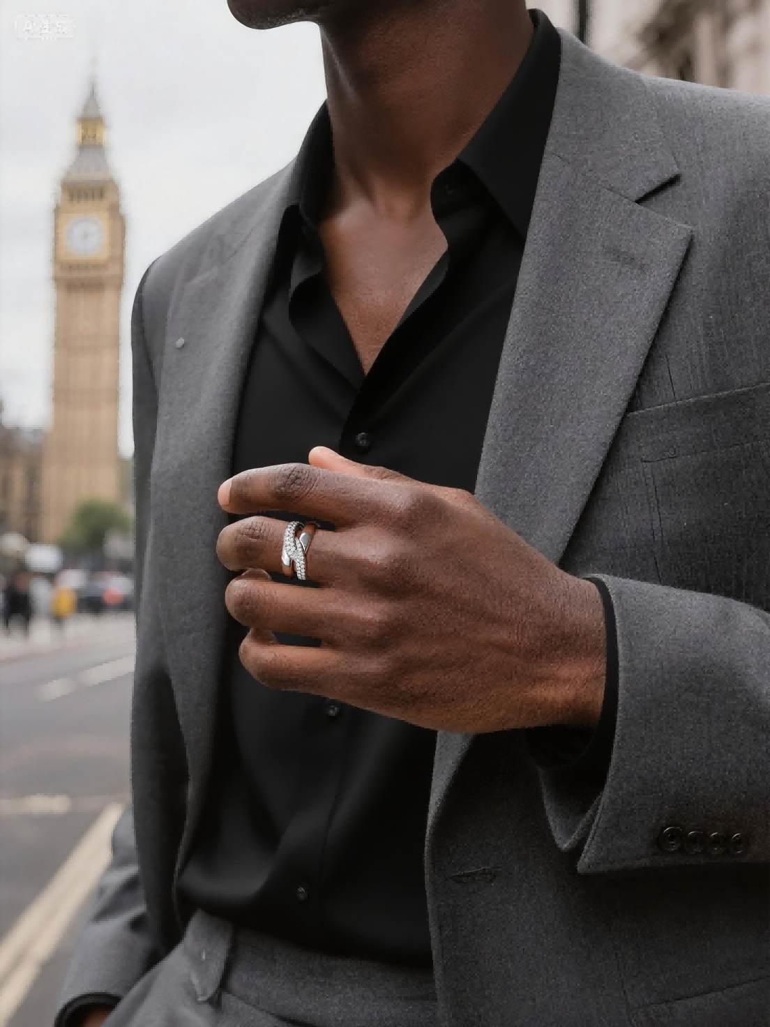 Own Your Bloom silver diamond crossover ring on man’s hand in business attire, stylish luxury jewelry look, Los Angeles.