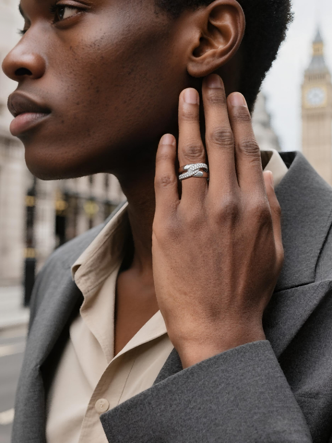 Own Your Bloom sterling silver intertwined crossover ring worn by man enjoying coffee outdoors, sophisticated style, Miami.