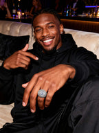 Male model wearing Own Your Bloom 14K white gold–plated wide-band pavé ring, on-hand lifestyle shot.