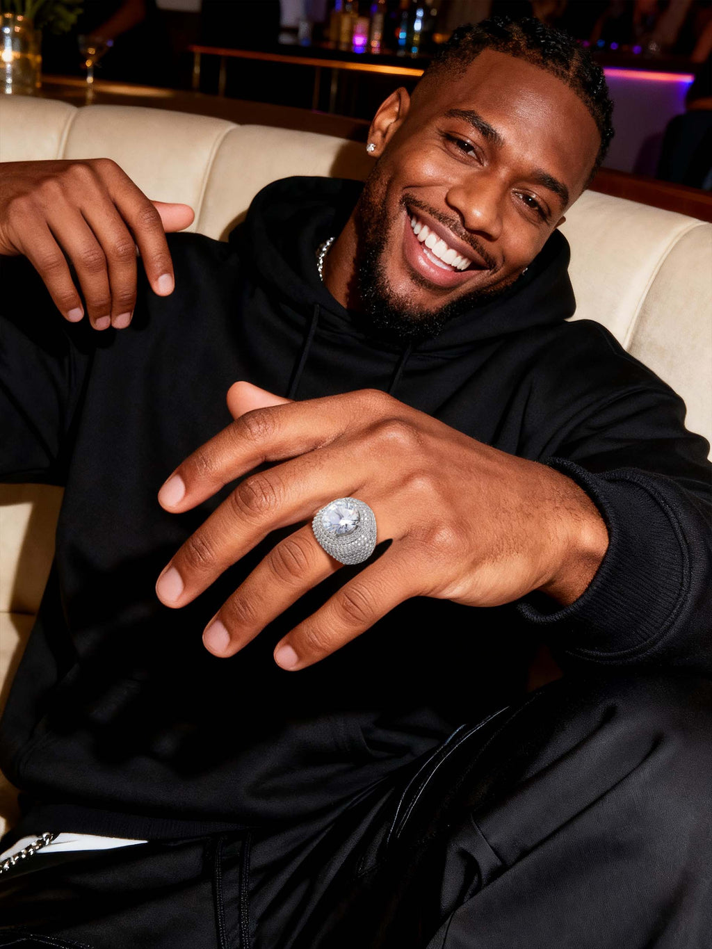 Close-up on hand showing the Own Your Bloom wide-band pavé ring with statement center stone.