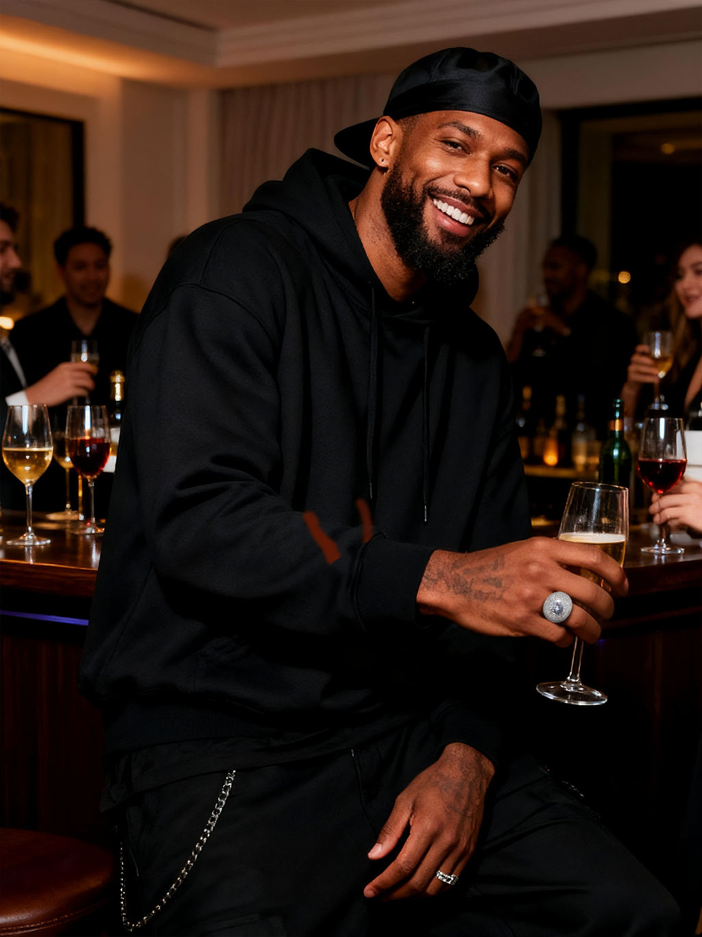 Lifestyle bar-scene shot of Own Your Bloom wide-band pavé ring in white-gold-plated finish.