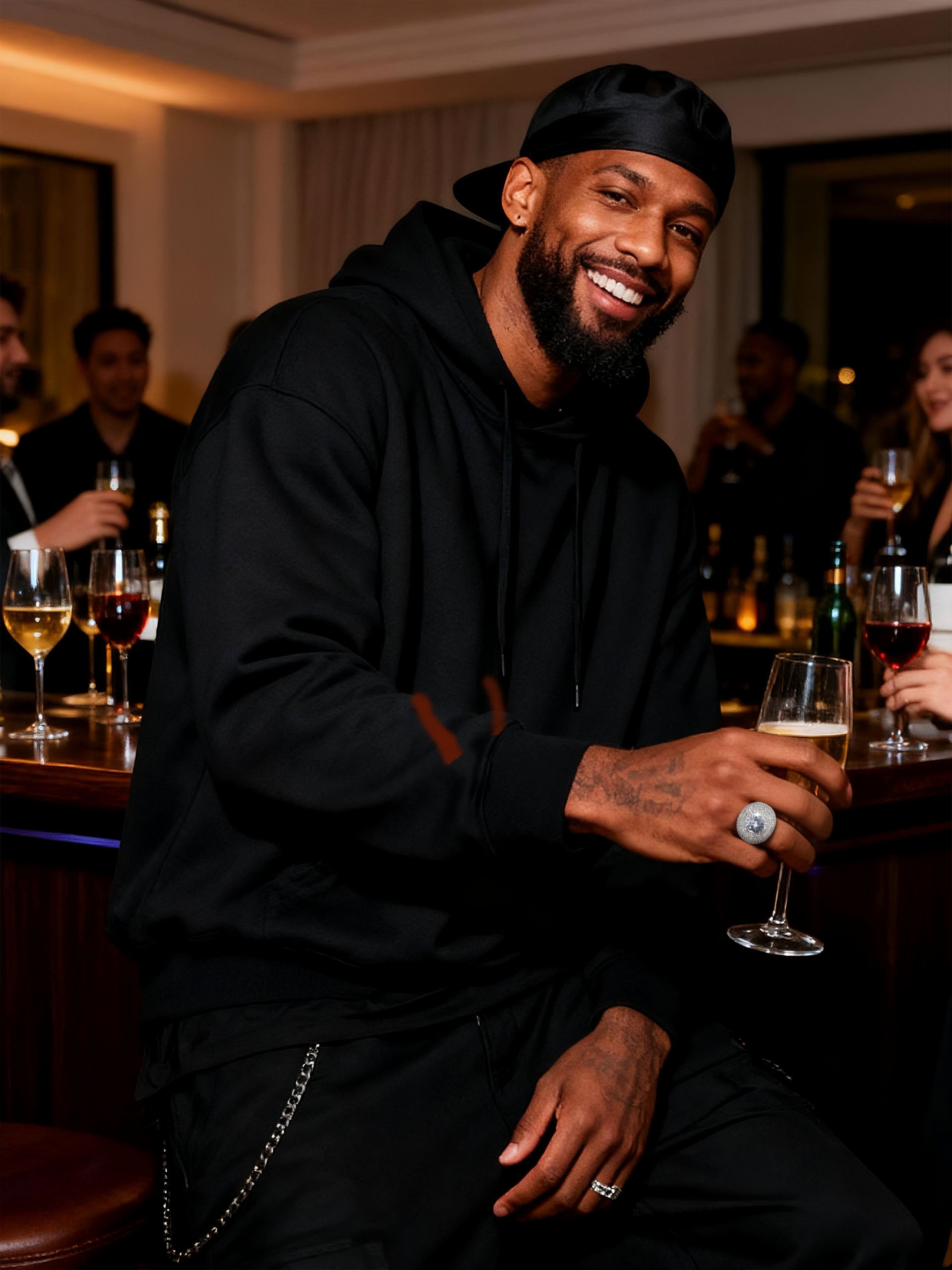 Lifestyle bar-scene shot of Own Your Bloom wide-band pavé ring in white-gold-plated finish.