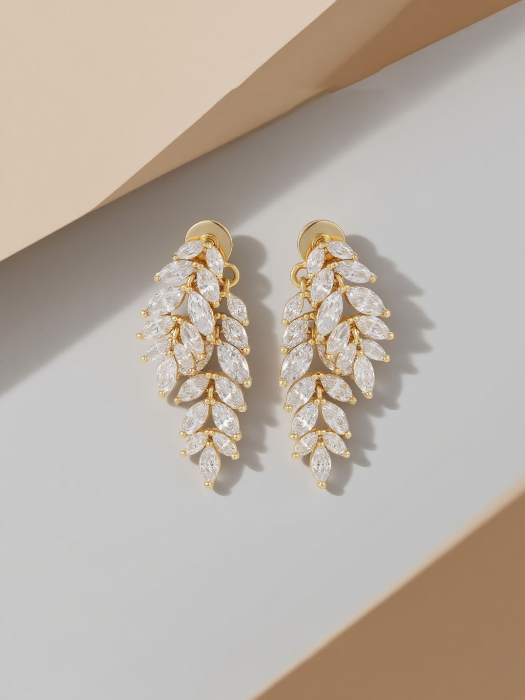 Own Your Bloom Willow Leaf Diamond 14k stud earrings styled flatlay on geometric set, Dallas.